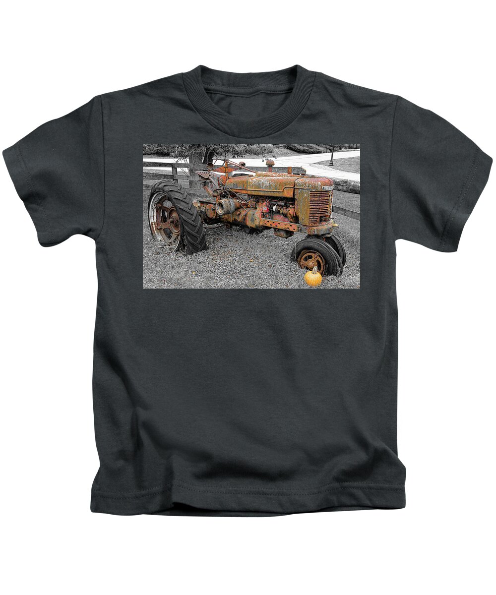 Old Red Tractor Farm Antique Flat Tire Pumpkin Fall October B&w Isolate Color Kids T-Shirt featuring the photograph Old Red Tractor by David Morehead
