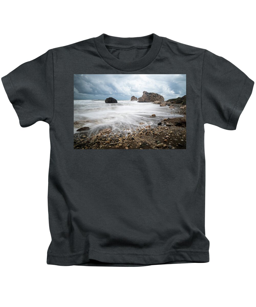 Sea Waves Kids T-Shirt featuring the photograph Seascape with windy waves during stormy weather on a rocky coast by Michalakis Ppalis