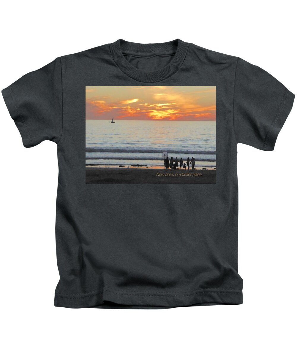 Ocean Water Sunset Orange Pink Blue Purple Black People Silhouettes Child Beach Blonde Sand Sailboat Waves Kids T-Shirt featuring the digital art She Is In A Better Place by Kathleen Boyles
