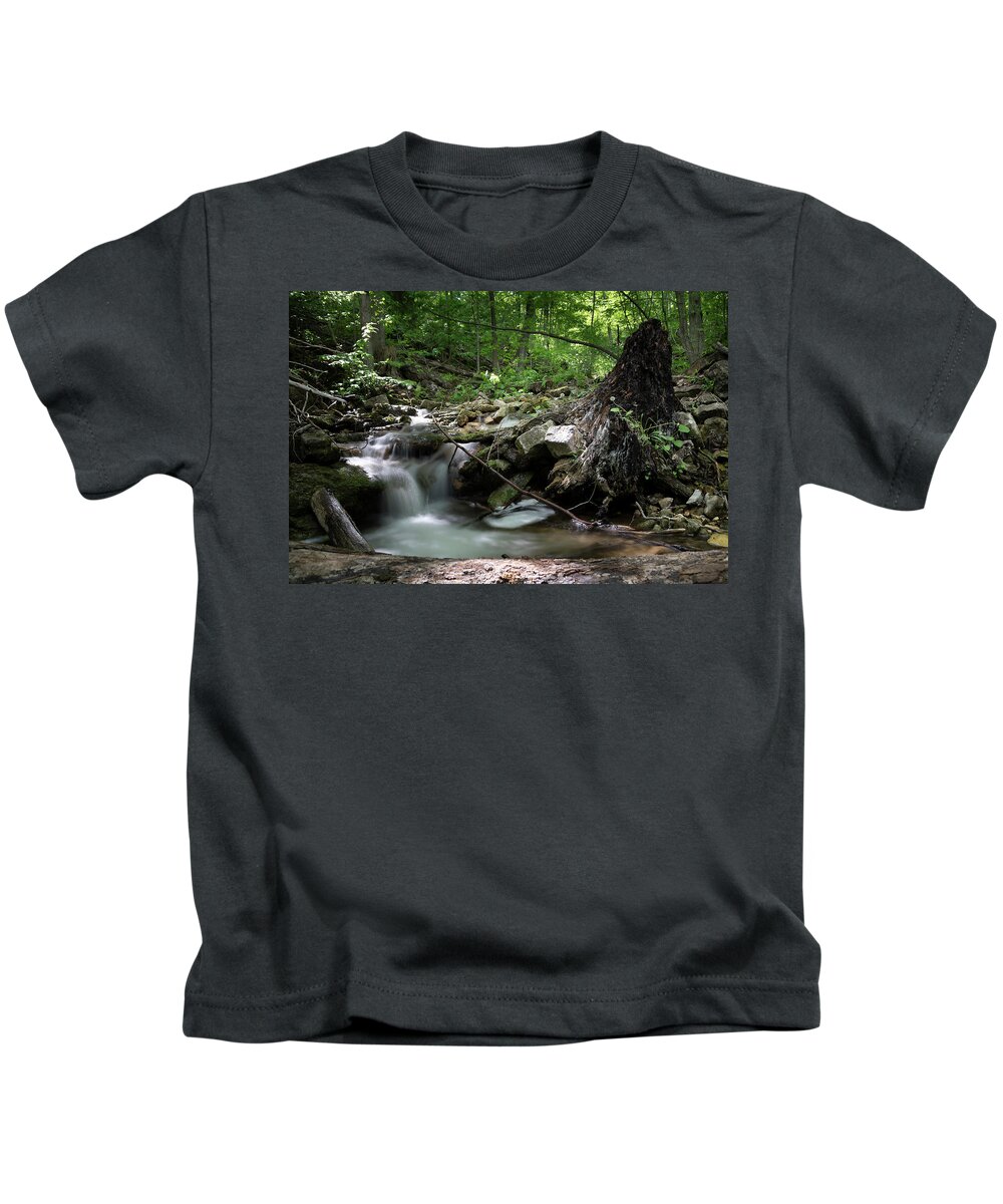 Waterfall Kids T-Shirt featuring the photograph Waterfall Cascading into a Pool in a Forest by John Twynam
