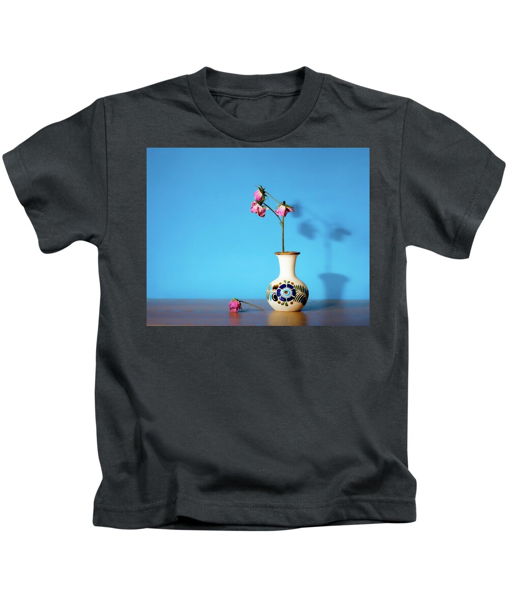 Still Life Kids T-Shirt featuring the photograph Wilted roses against blue by Alessandra RC