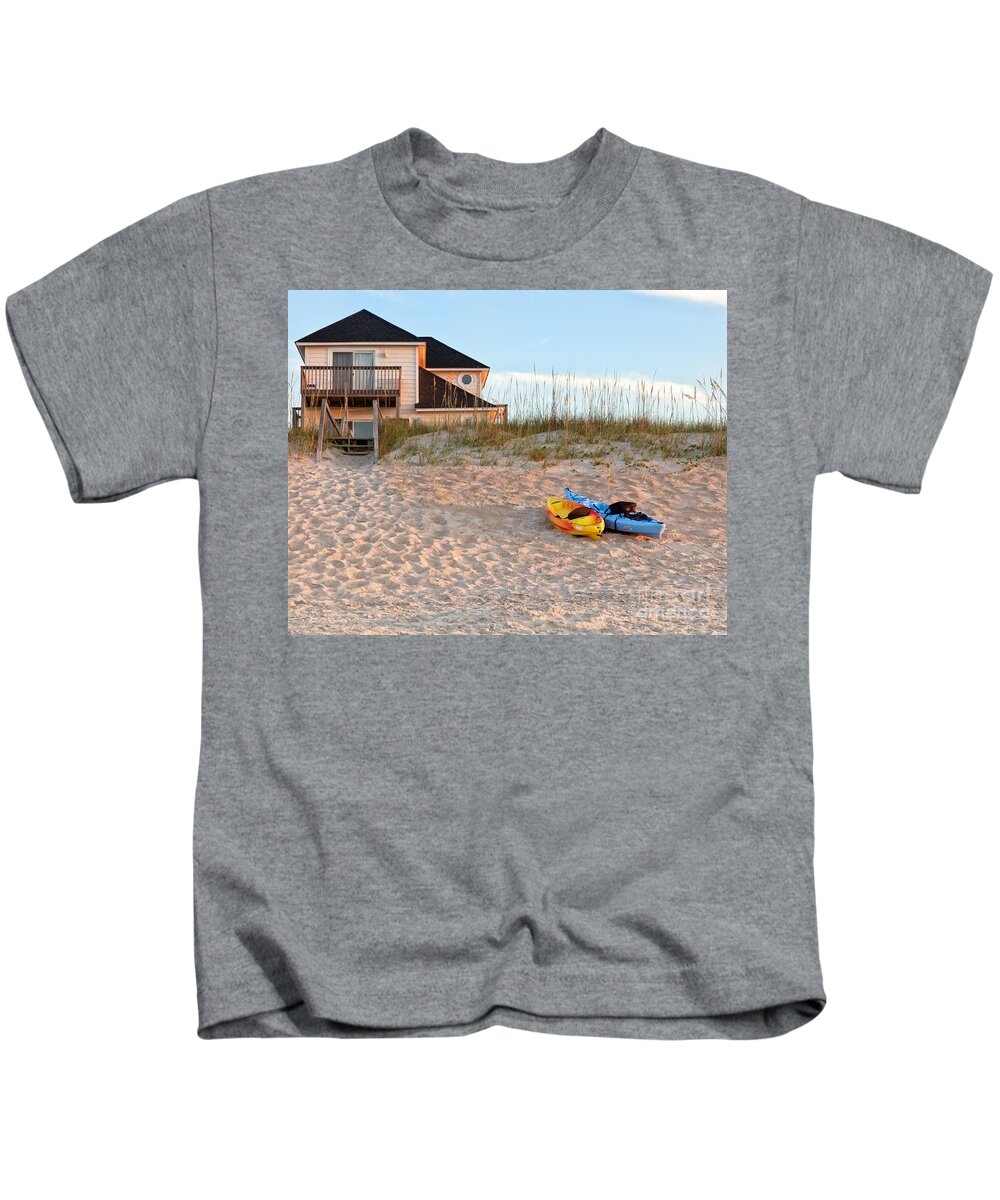 Active Kids T-Shirt featuring the photograph Kayaks Rest On Sand Dune In Morning Sun. by Jo Ann Tomaselli
