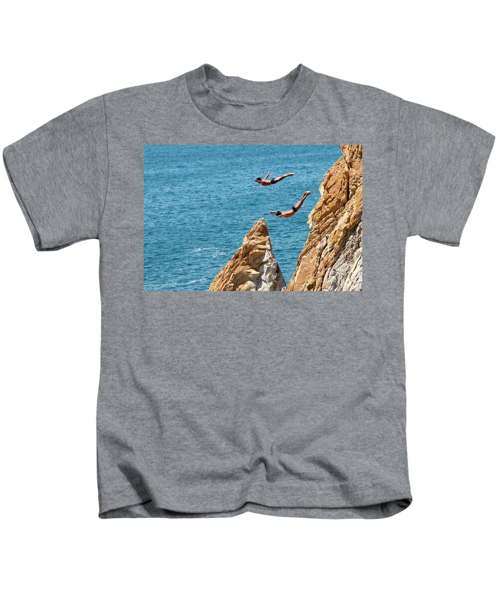 Cliff Divers Kids T-Shirt featuring the photograph Famous cliff diver of Acapulco Mexico #3 by Anthony Totah