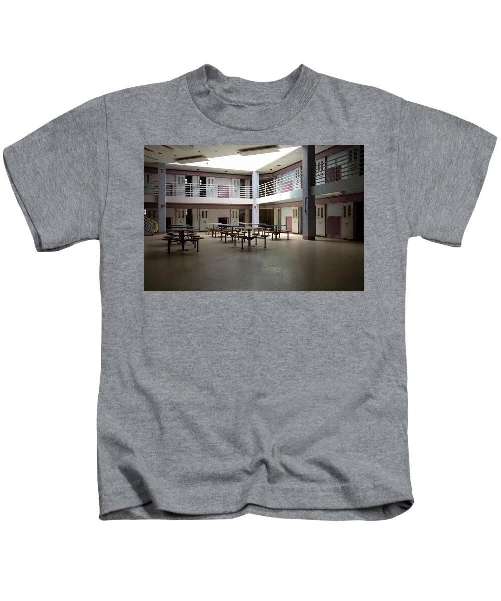 America Kids T-Shirt featuring the photograph Abandoned jail common room in cell block by Karen Foley