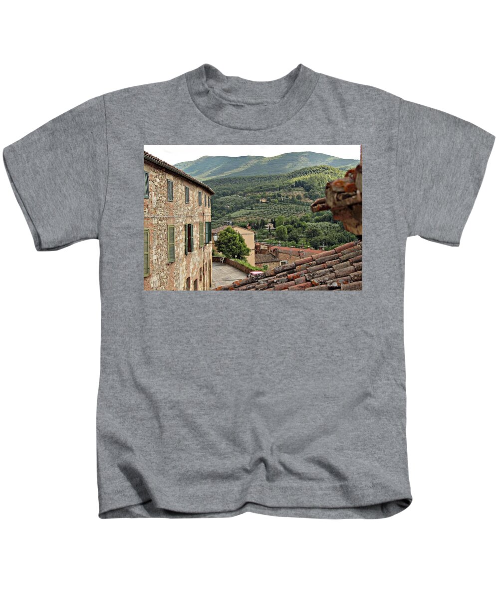 #tuscany #italy #cetona #windows #stonework #summer #europe #history #historic Kids T-Shirt featuring the photograph Early morning rooftops by Jacci Freimond Rudling