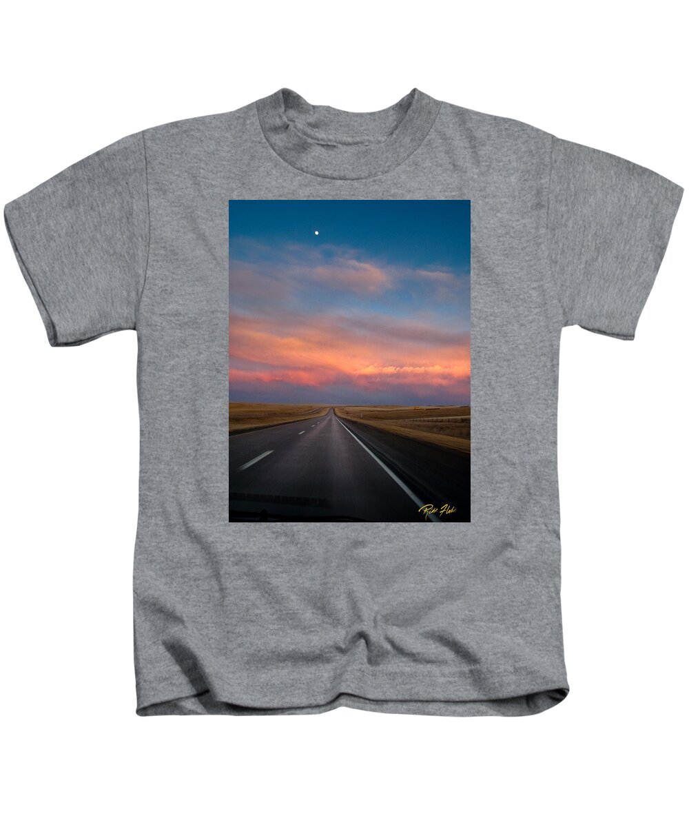 Atmosphere Kids T-Shirt featuring the photograph Moonrise and Sunset on I-90 by Rikk Flohr