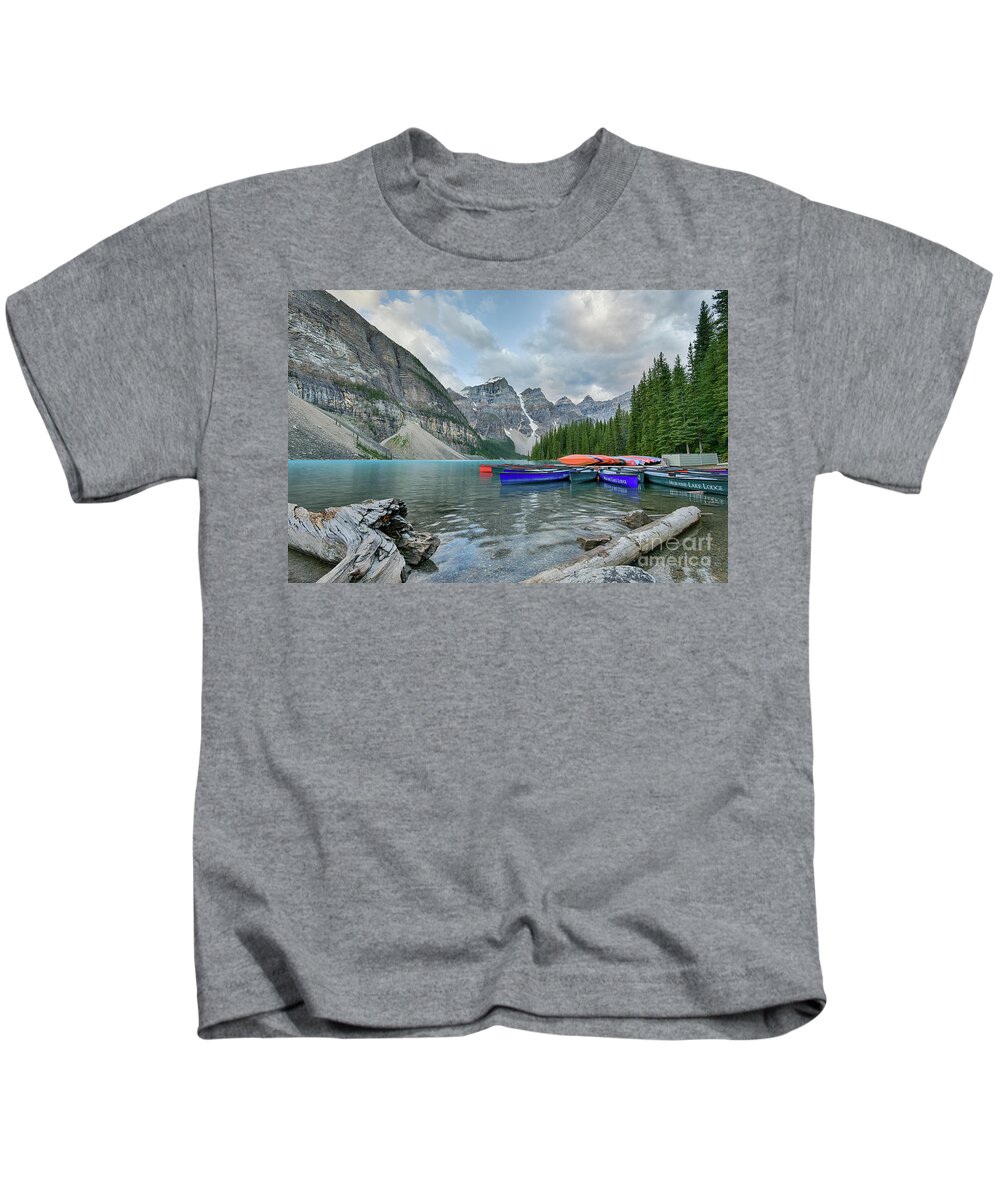 Moraine Lake Kids T-Shirt featuring the photograph Moraine logs and canoes by Paul Quinn