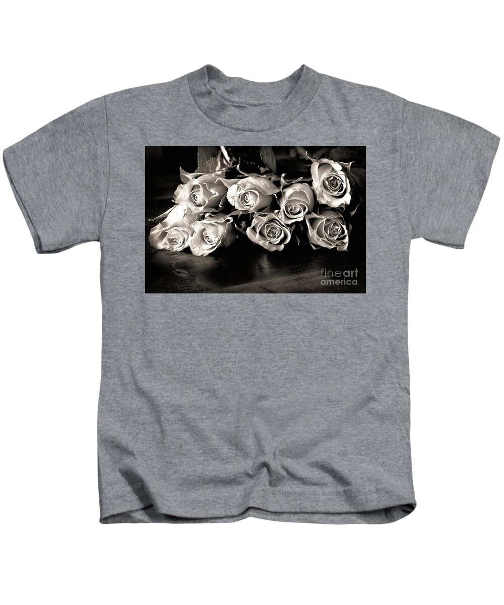 Roses Kids T-Shirt featuring the photograph Roses on a table in black and white by Simon Bratt