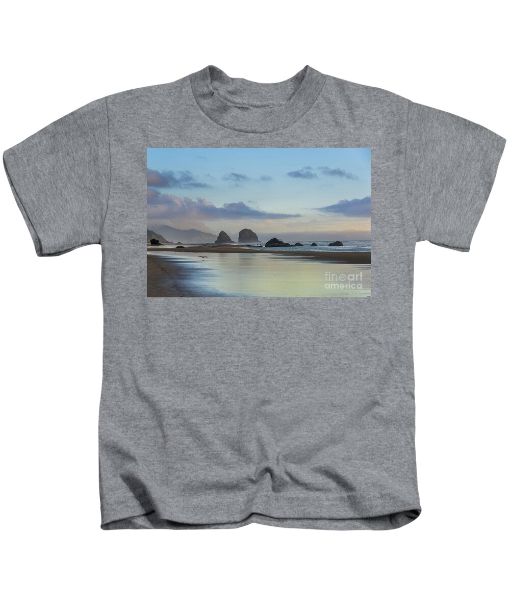 Cannon Beach Kids T-Shirt featuring the photograph Skimming along the beach at sunset by Paul Quinn