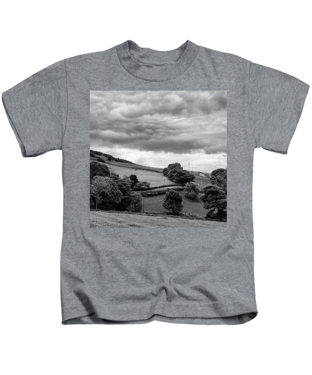  Kids T-Shirt featuring the photograph The Rolling Hills And Looming Clouds by Aleck Cartwright