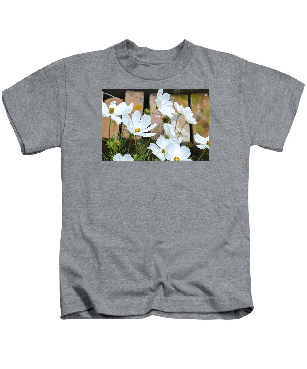 White Flowers Kids T-Shirt featuring the photograph White Flowers Against Bricks by Lynn Hansen