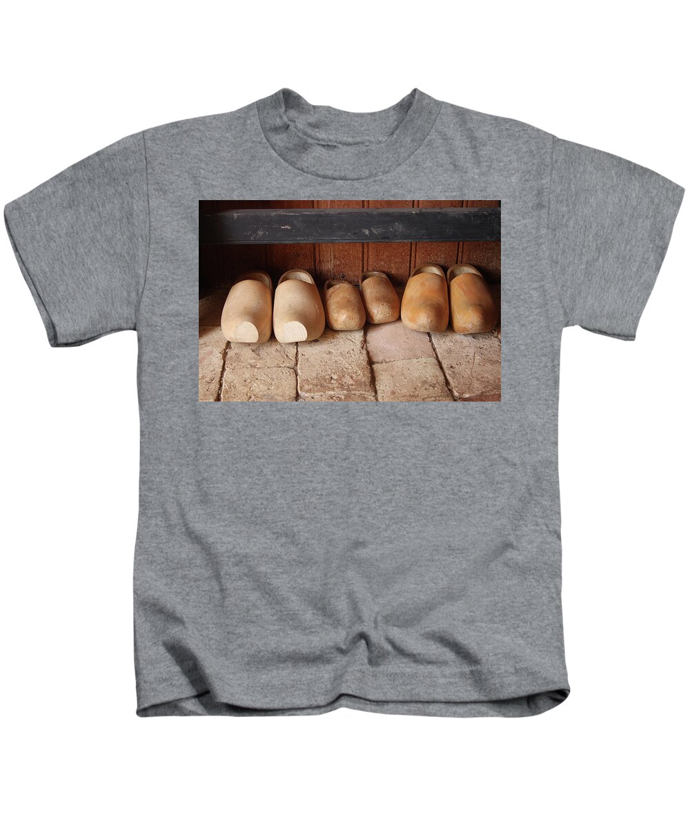 Clogs Kids T-Shirt featuring the photograph Wooden clogs by Emanuel Tanjala