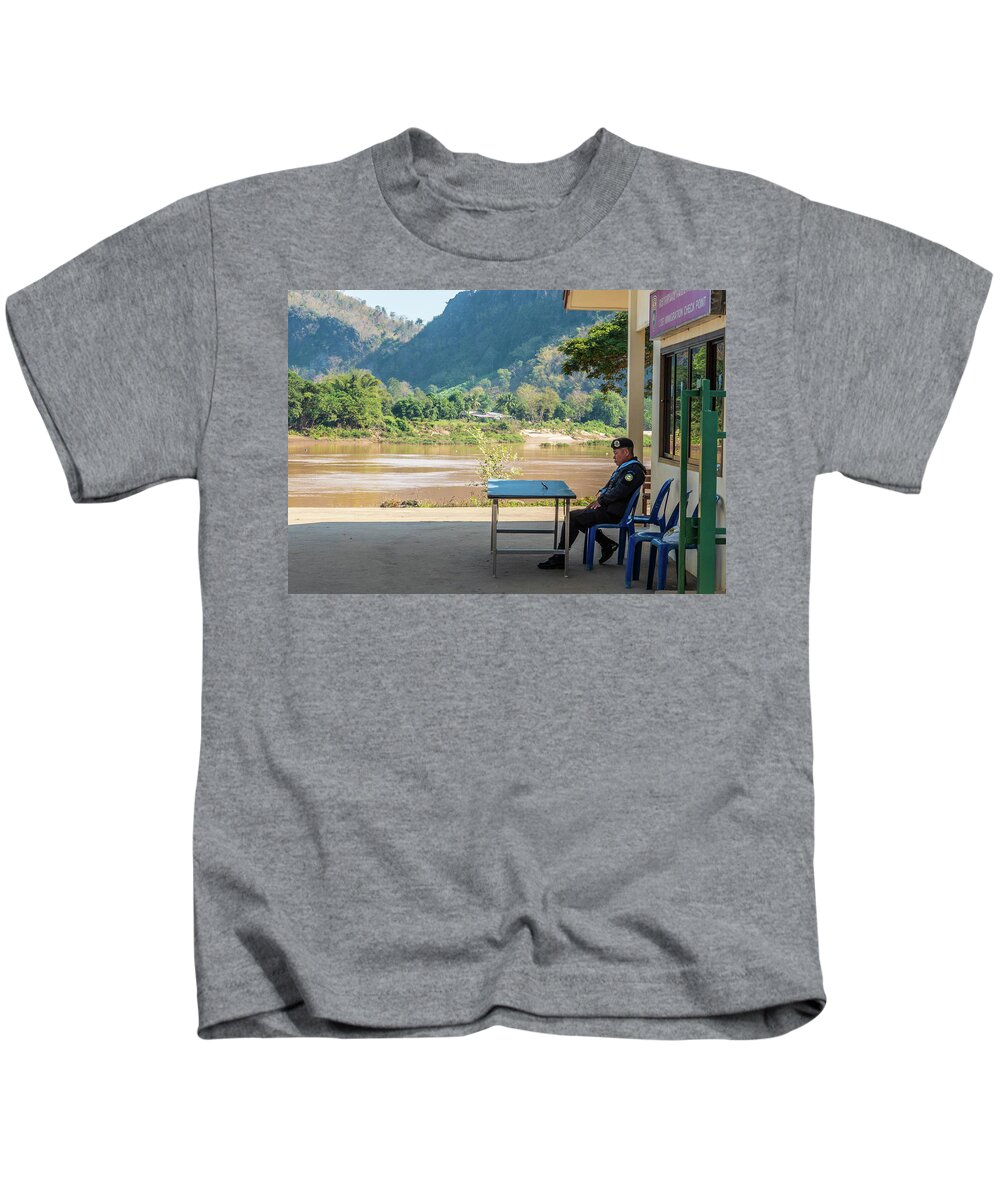 Laos Kids T-Shirt featuring the photograph Border guard hard at work by Jeremy Holton