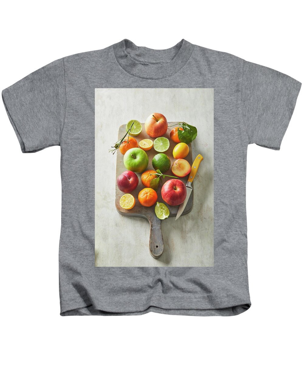 Cuisine At Home Kids T-Shirt featuring the photograph Fruit on a cutting board by Cuisine at Home