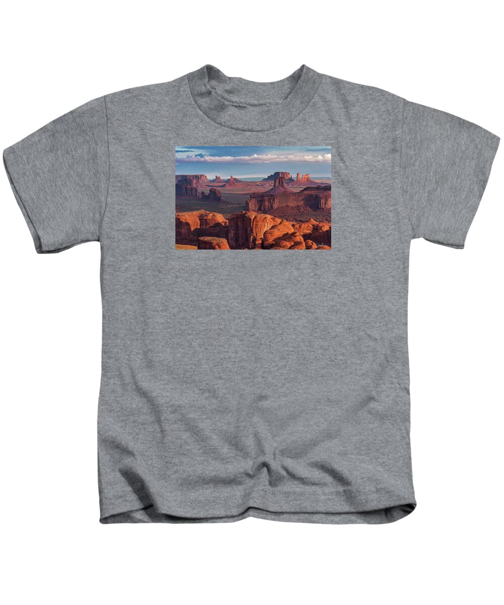 Southwest Desert Arizona Monument Valley Dineh Sunrise Stagecoach Red Rock Colorado Plateau Kids T-Shirt featuring the photograph Sunrise from Hunt's Mesa #1 by Dan Norris