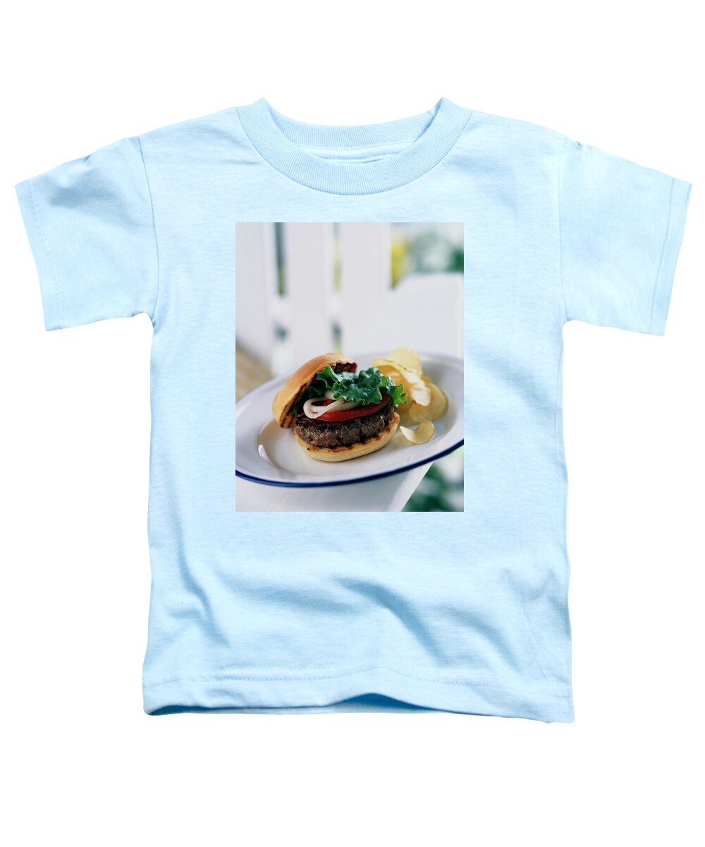 Cooking Toddler T-Shirt featuring the photograph A Burger With Potato Chips by Romulo Yanes
