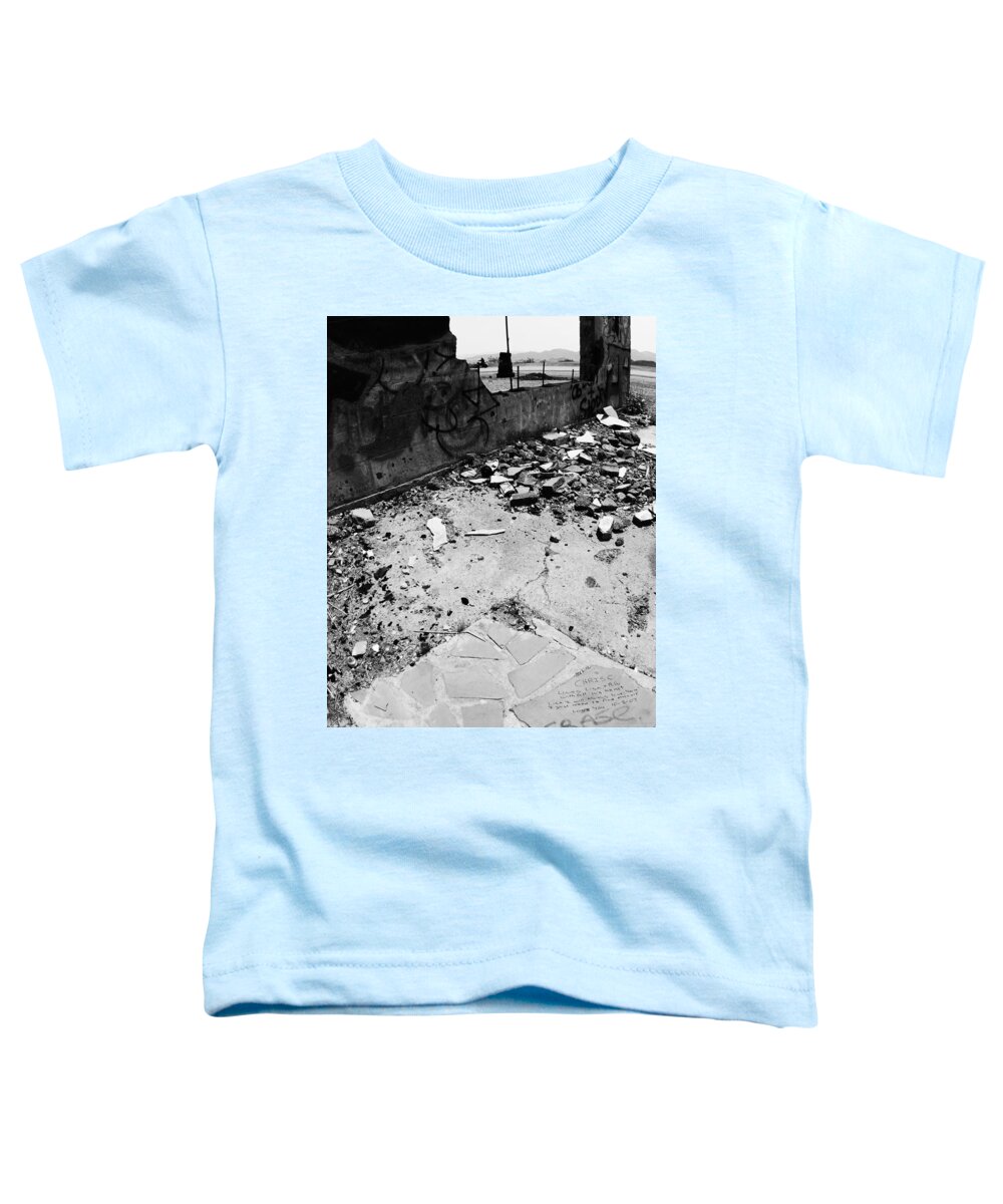 Left Behind In The Rubble Toddler T-Shirt featuring the photograph Left Behind in the Rubble -- Motorcyclist and Graffiti in Amboy, California by Darin Volpe