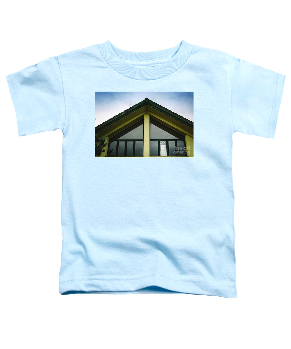 Background Toddler T-Shirt featuring the photograph Wedding dress hanging from a window seen from outside with intense blue sky. by Joaquin Corbalan