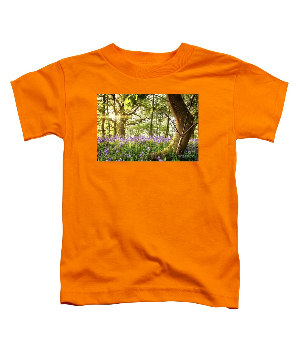 Forest Toddler T-Shirt featuring the photograph Bent tree in bluebell forest by Simon Bratt