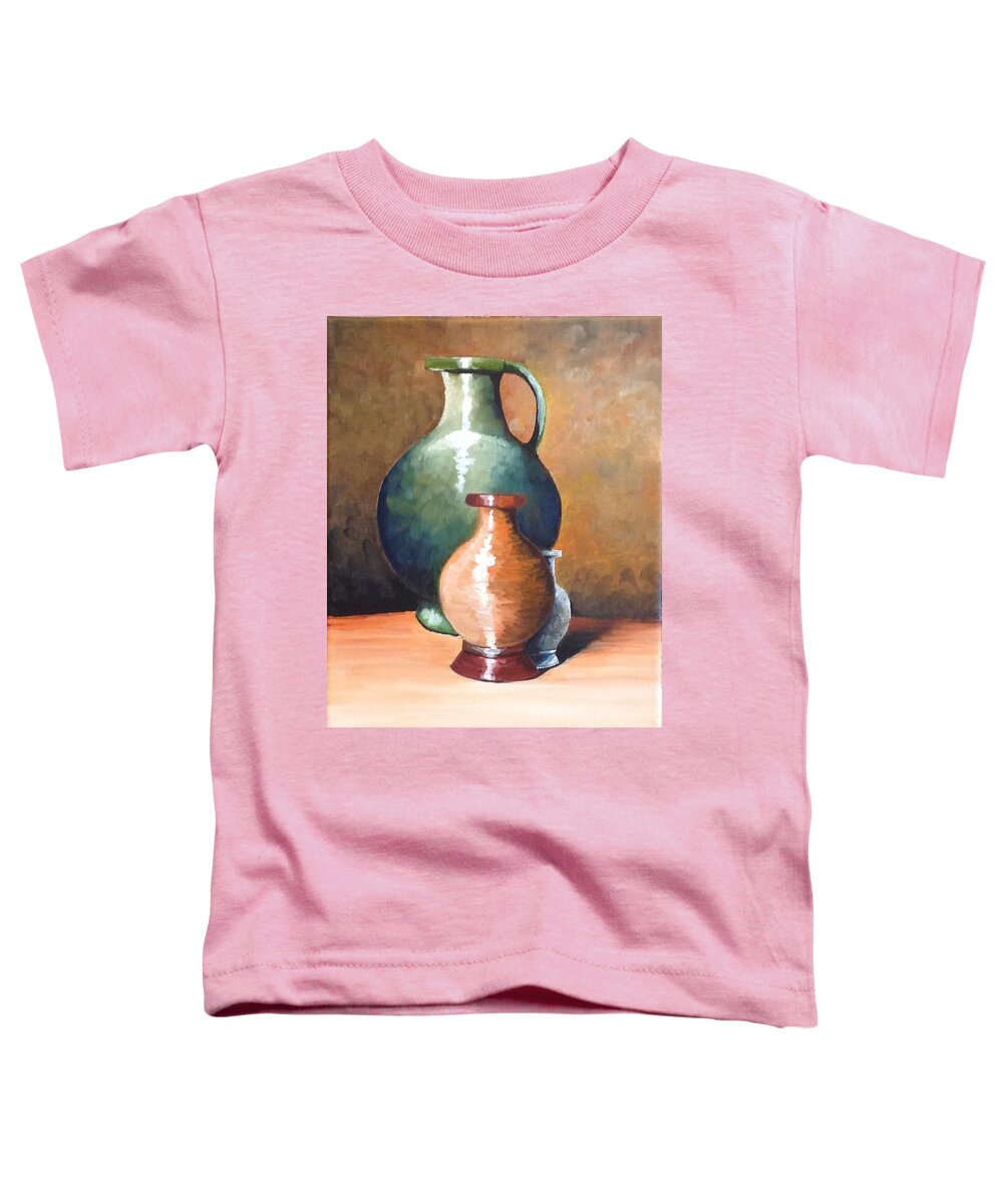 This Is A Still Life Of Three Ceramic Pitchers With Different Colors. The Two Large Pitchers Have A Reflective Surface. They Are Staged In The Corner Of A Small Counter. The Background Was Done With Many Different Colors To Portray A Old Wall Paper.  Toddler T-Shirt featuring the painting Three Pitchers by Martin Schmidt