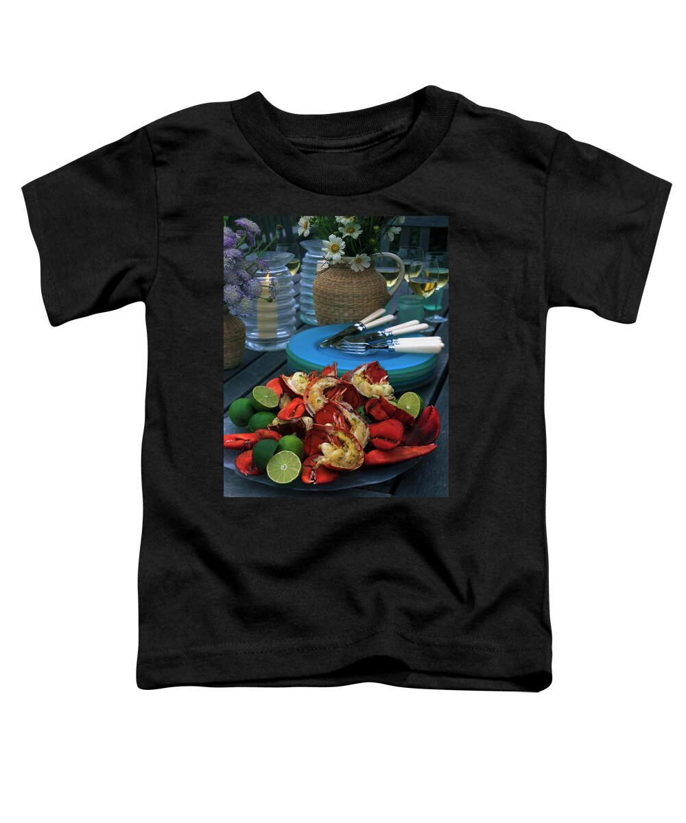 Still Life Toddler T-Shirt featuring the photograph A Meal With Lobster And Limes by Romulo Yanes