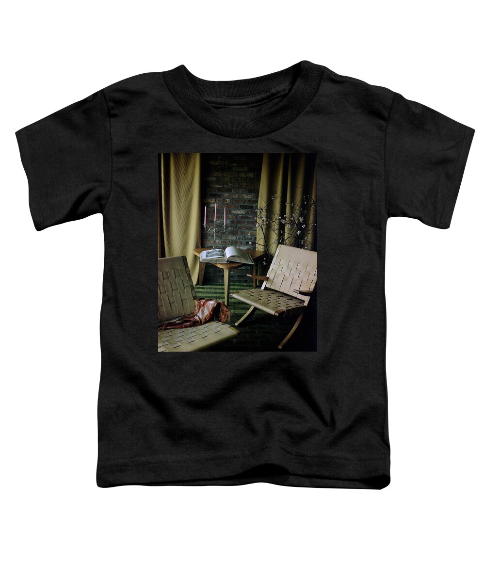 Nobody Toddler T-Shirt featuring the photograph An Armchair Beside A Table And An Old Book by Horst P. Horst
