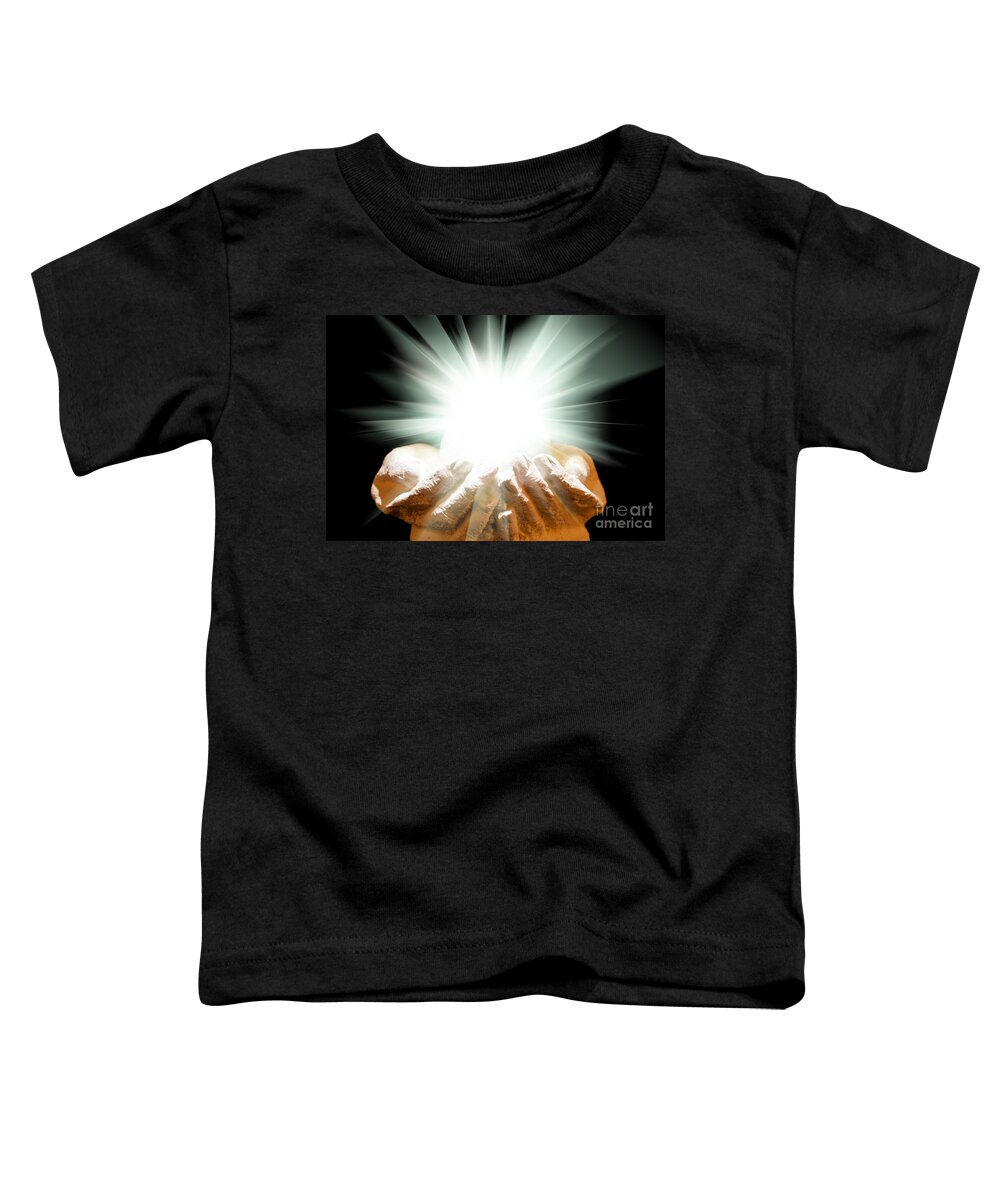Spiritual Toddler T-Shirt featuring the photograph Spiritual light in cupped hands on a black background by Simon Bratt