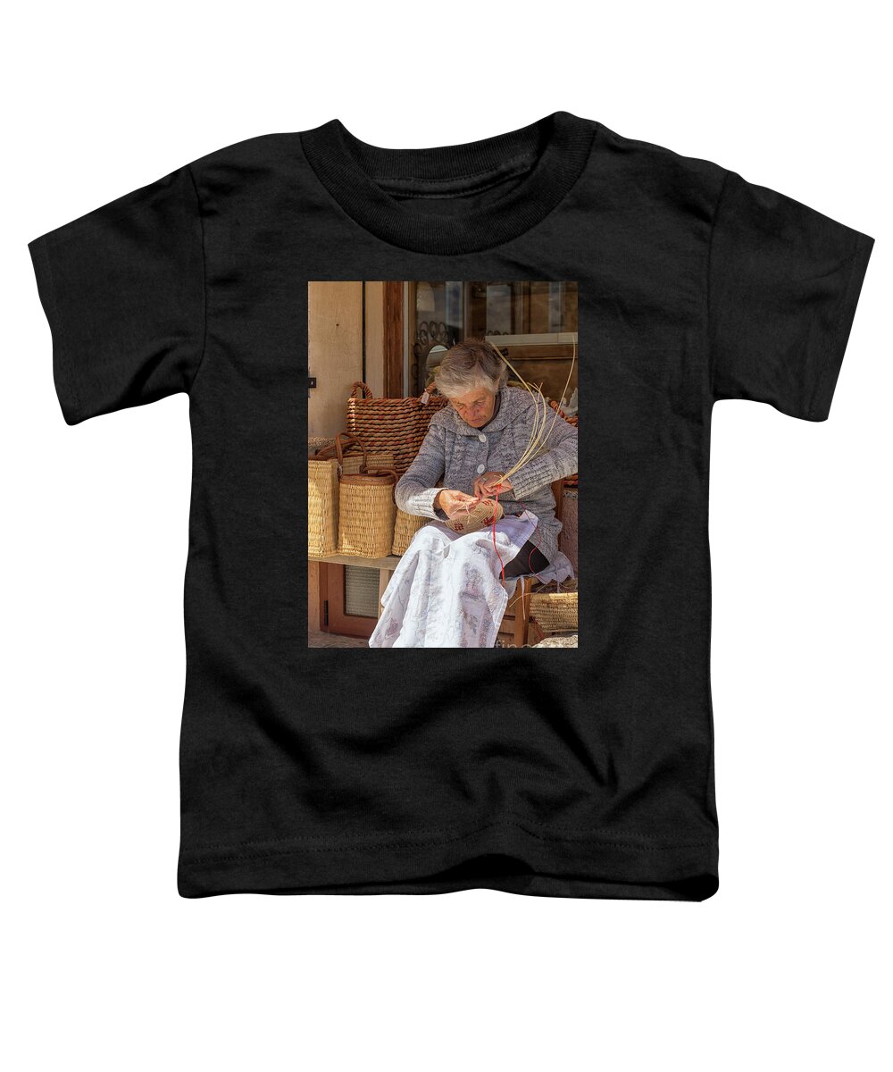 Adult Toddler T-Shirt featuring the photograph A woman weaving a basket in Castelsardo by Patricia Hofmeester