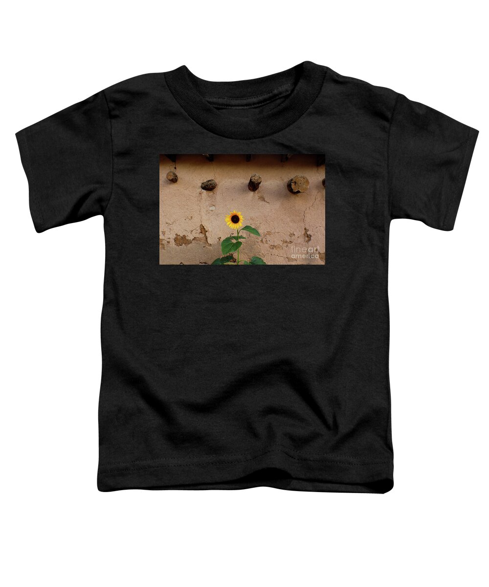 White Toddler T-Shirt featuring the photograph Sunflower and Stucco by Susan Vineyard