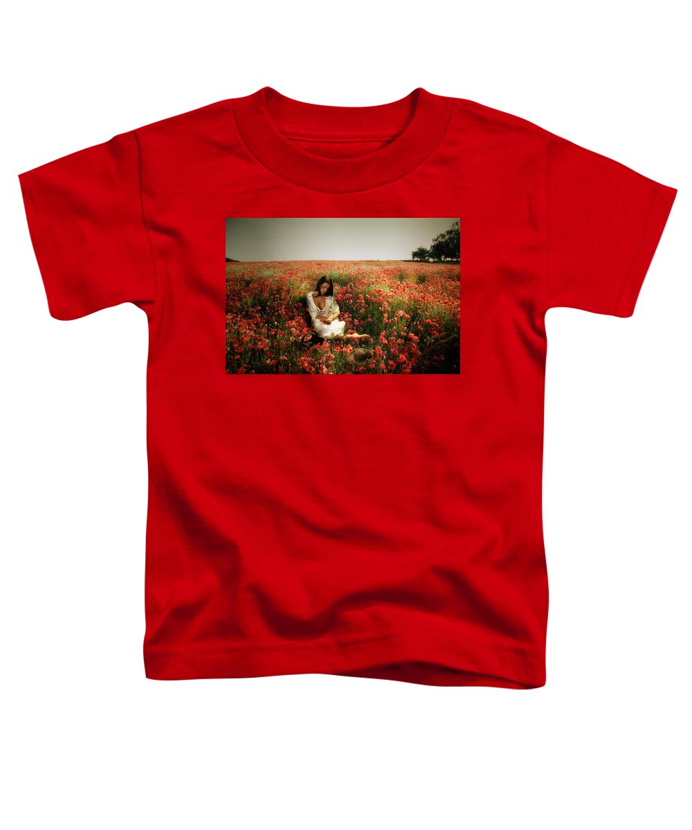 Portrait. Poppies Toddler T-Shirt featuring the photograph A girl reading amongst he Poppies by Mark Egerton