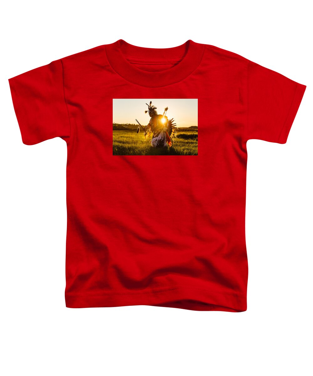 A Traditional Native American Indian Dances At Sunset At A Powwow In Montana. Toddler T-Shirt featuring the photograph Sun Dance by Todd Klassy