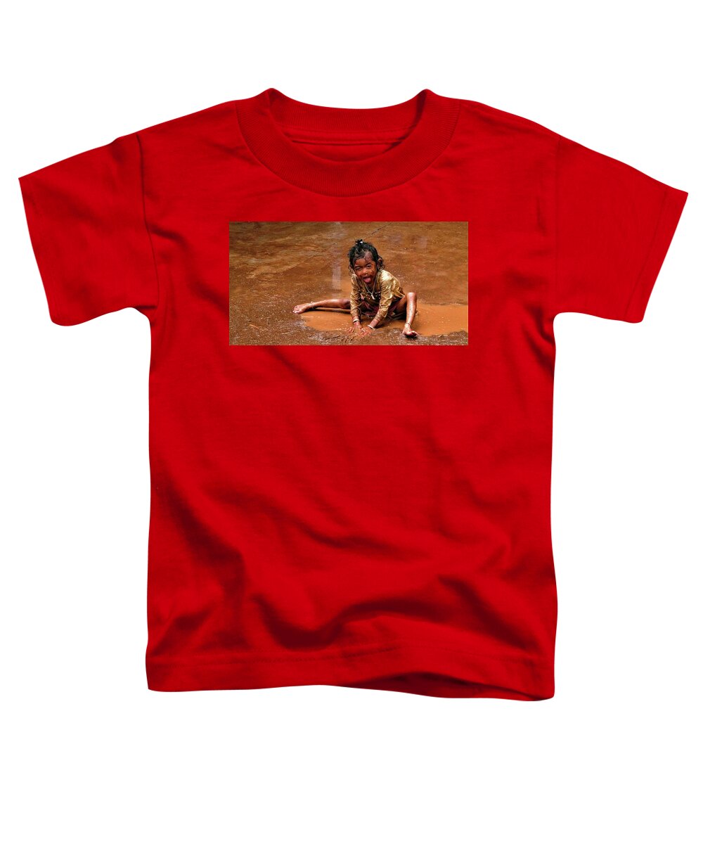 Puddle Toddler T-Shirt featuring the photograph Girl in the puddle of brown water by Robert Bociaga