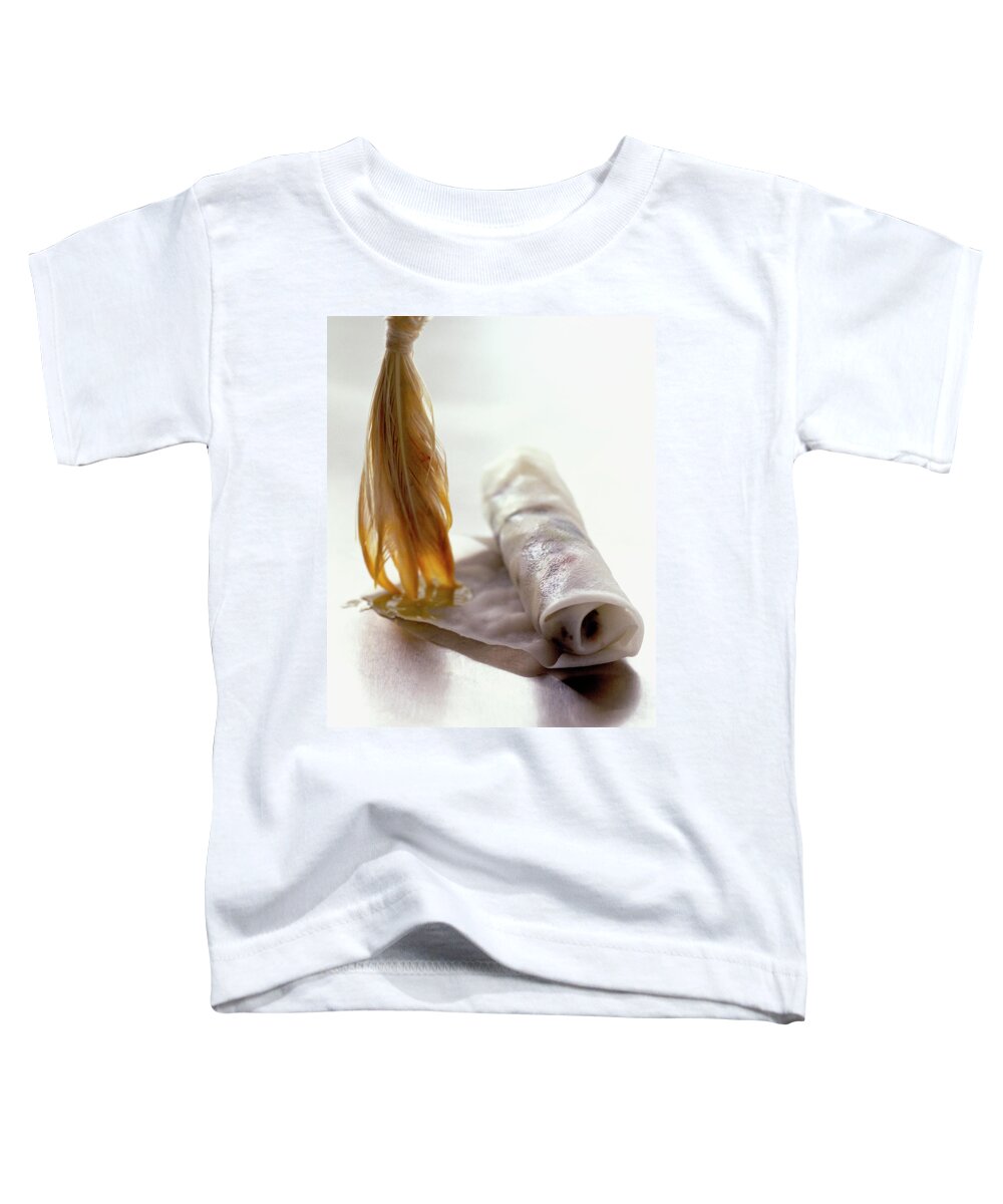Cooking Toddler T-Shirt featuring the photograph An Egg Roll by Romulo Yanes
