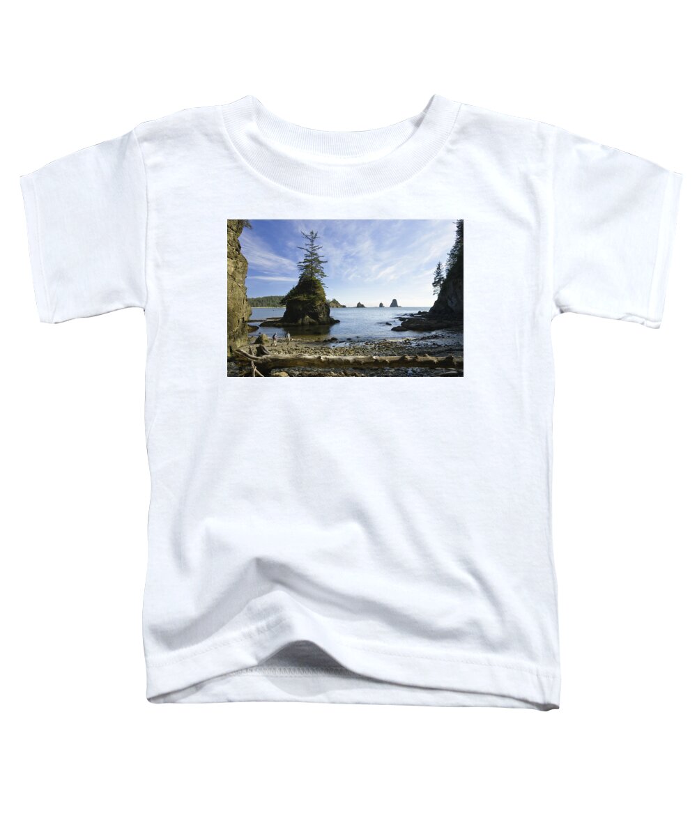 Mp Toddler T-Shirt featuring the photograph Two Hikers Walk On Beach With Sea by Konrad Wothe