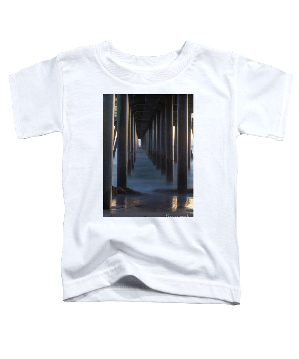  Huntington Beach Toddler T-Shirt featuring the photograph Between The Pillars by Brandon Bonafede