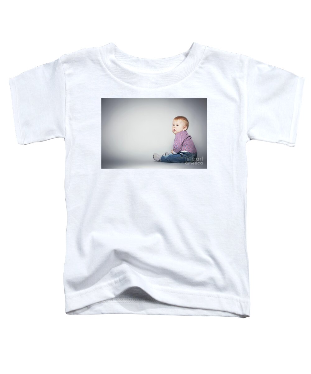 Baby Toddler T-Shirt featuring the photograph Cute toddler sitting on the floor. by Michal Bednarek