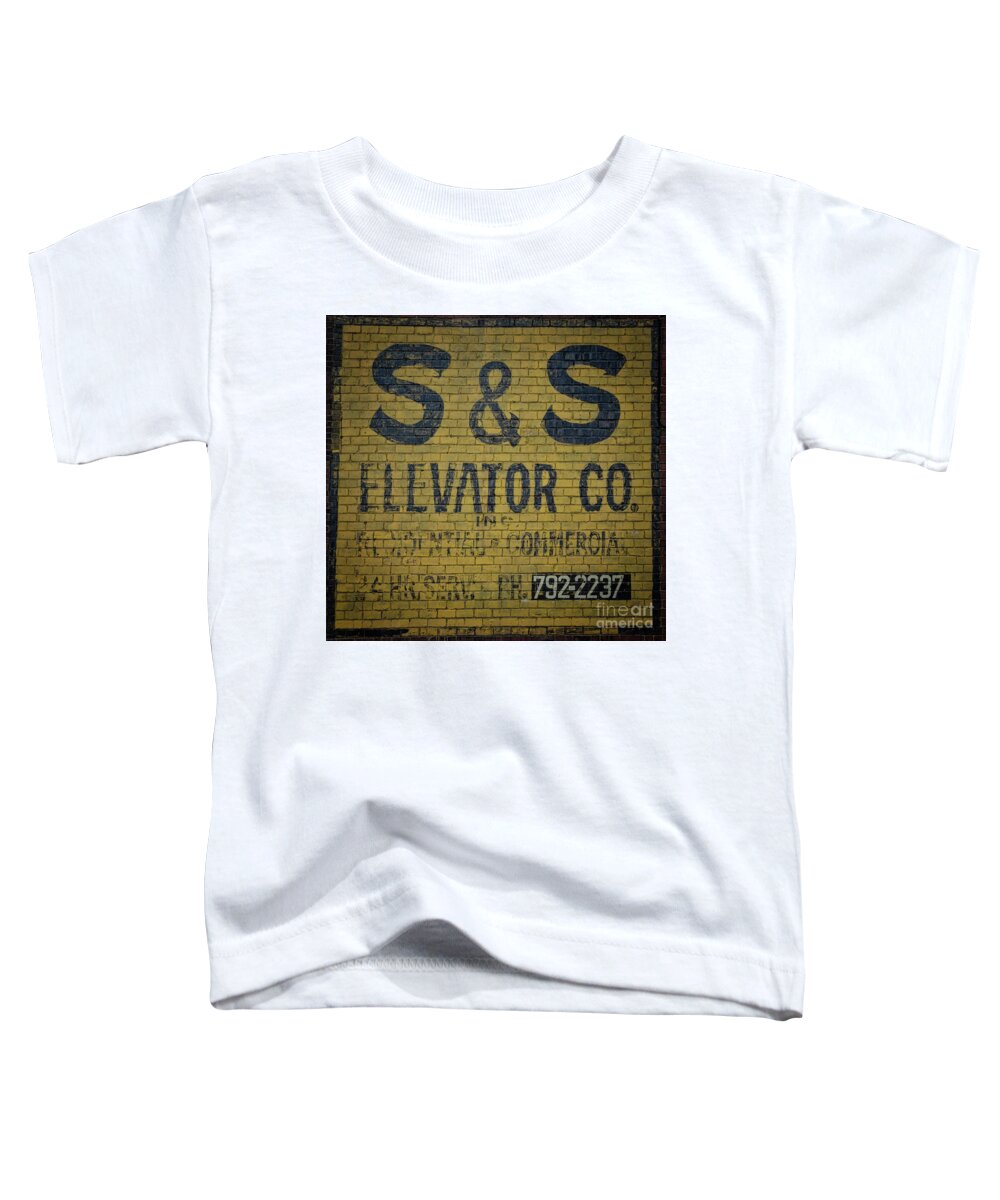 Wall Toddler T-Shirt featuring the photograph Ghost Sign Elevator Company by Janice Pariza