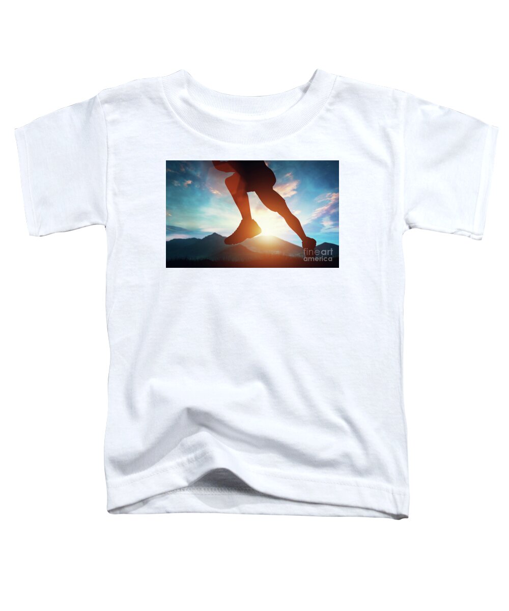 Man Toddler T-Shirt featuring the photograph Man running in the mountains at the sunset. by Michal Bednarek