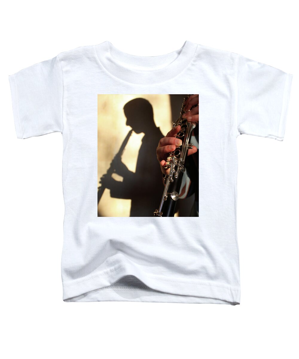 Shadow Toddler T-Shirt featuring the photograph Shadow of a clarinetist by Gregory DUBUS