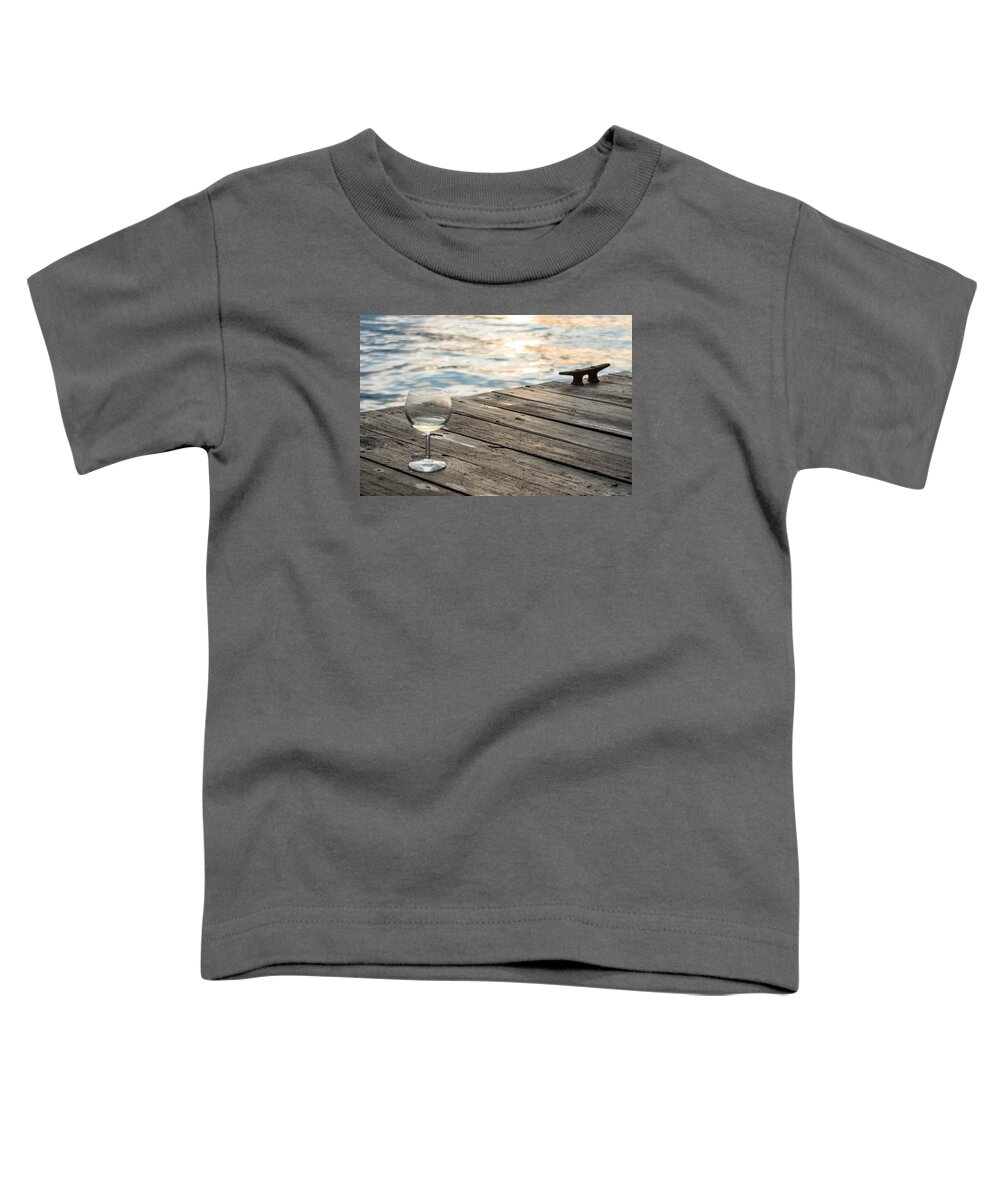 Glass Toddler T-Shirt featuring the photograph Finger lakes wine tasting - Wine Glass on the Dock by Photographic Arts And Design Studio