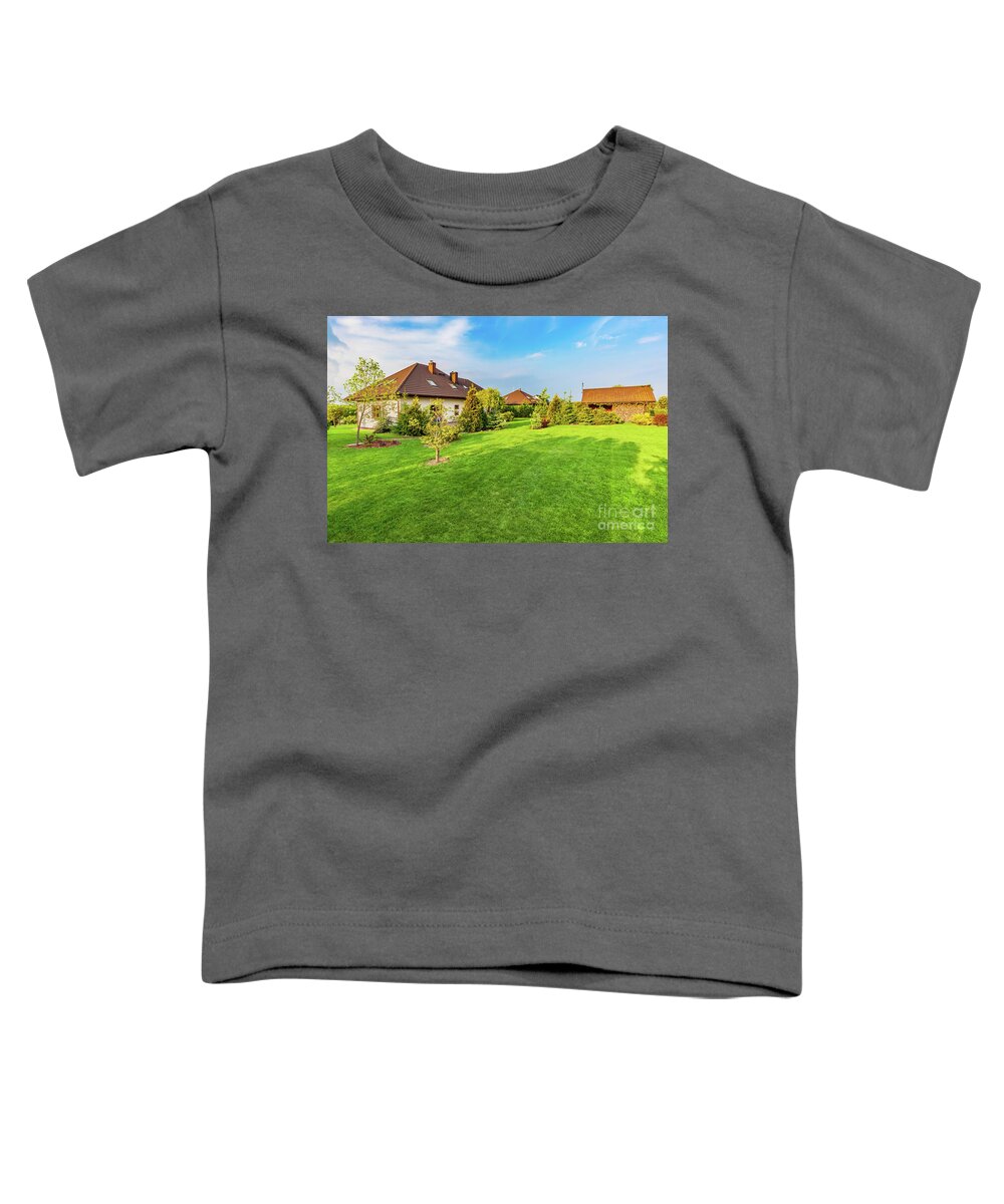 Garden Toddler T-Shirt featuring the photograph Backyard of a family house. Spacious landscaped garden with green mown grass by Michal Bednarek