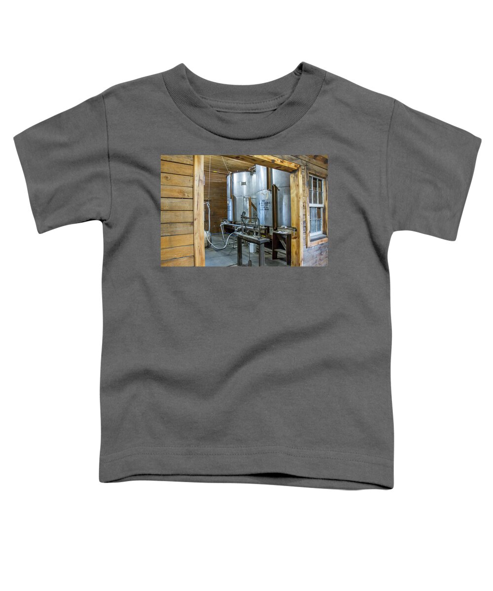American Toddler T-Shirt featuring the photograph Bourbon distillery barrel filling room by Karen Foley