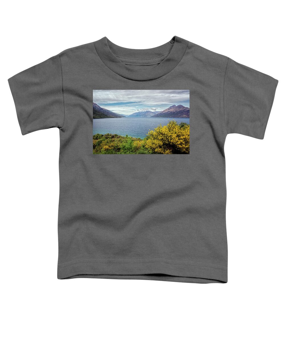 Joan Carroll Toddler T-Shirt featuring the photograph Broom Bushes on Lake Wakatipu New Zealand by Joan Carroll