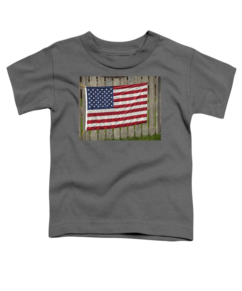 Flag Toddler T-Shirt featuring the photograph Flag on a Fence by Phil Cardamone