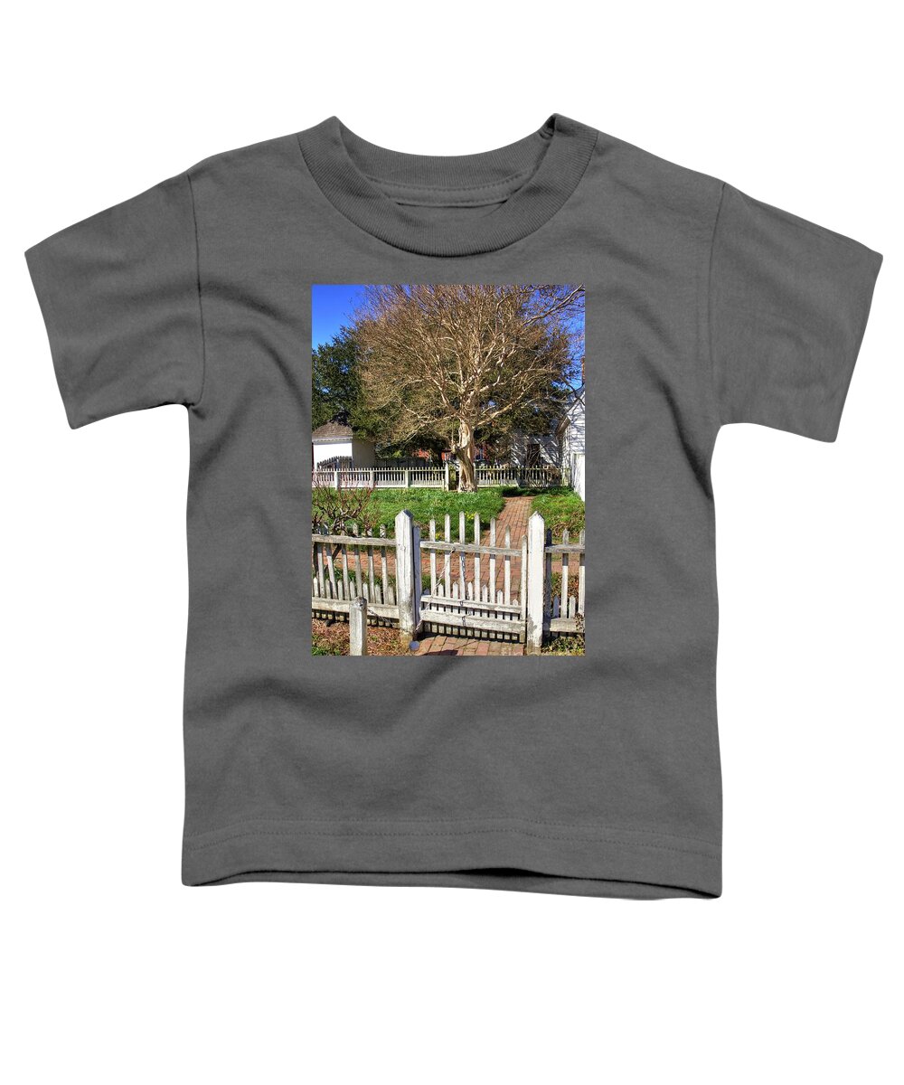 Garden Gate Colonial Williamsburg Virginia Tree Fence Blue Sky Spring Brick Path Ball And Chain Weighted Fence Toddler T-Shirt featuring the photograph Garden Gate Colonial Williamsburg Virginia II by Karen Jorstad
