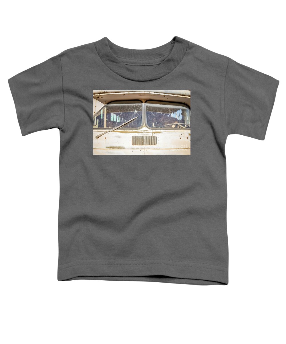 Junkyard Toddler T-Shirt featuring the photograph Front of an old Bus in a junkyard by Edward Fielding