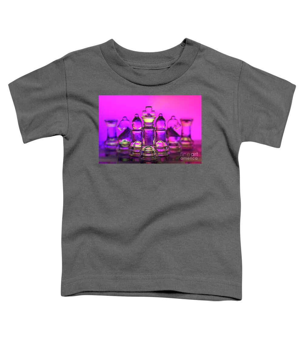 Defense Toddler T-Shirt featuring the photograph Chess figures made of glass. King in front magenta background macro by Pablo Avanzini