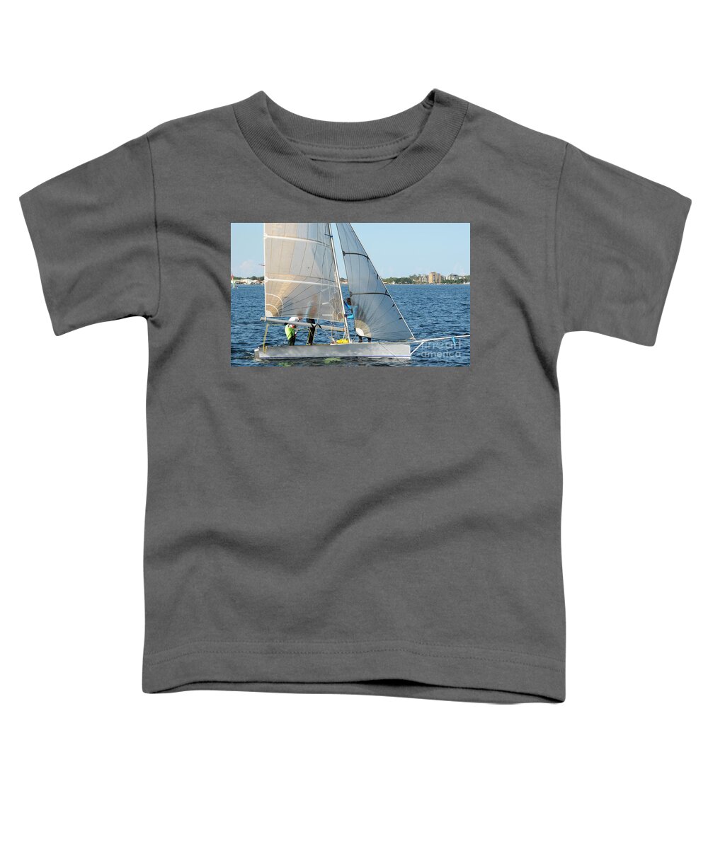 Sky Toddler T-Shirt featuring the photograph Children Sailing small dinghy with white sails up-close on an in by Geoff Childs