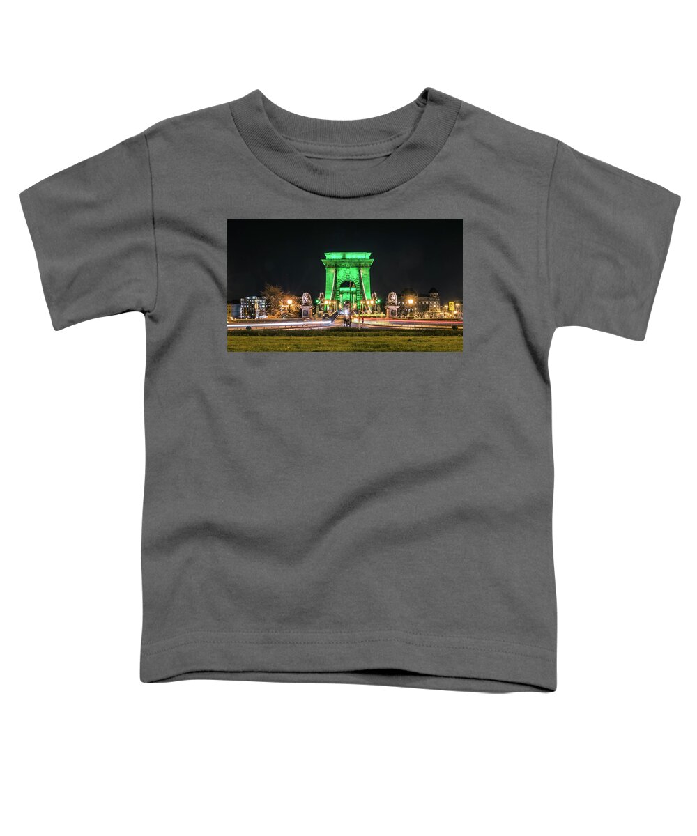 Budapest Toddler T-Shirt featuring the photograph The Chain Bridge in Budapest illuminated in Kelly Green for St. Patrick's Day. by Tito Slack