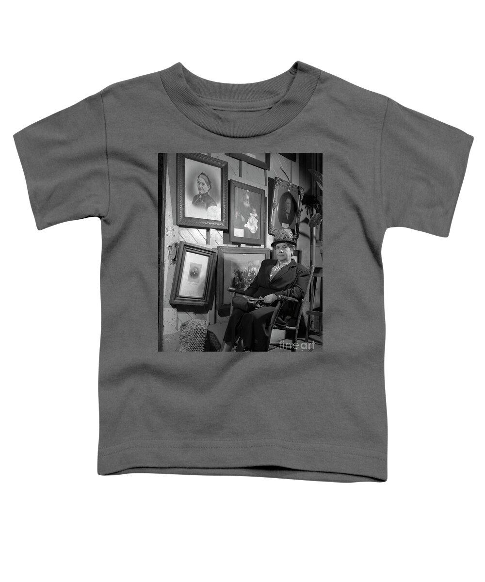 Genealogy Toddler T-Shirt featuring the photograph Woman seated in front of portraits of family members, 1946. by The Harrington Collection
